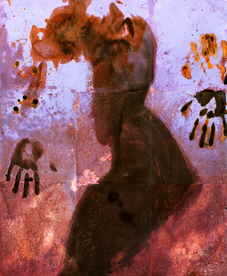 Pink background, lumen print, dark outline of a body and handprints.