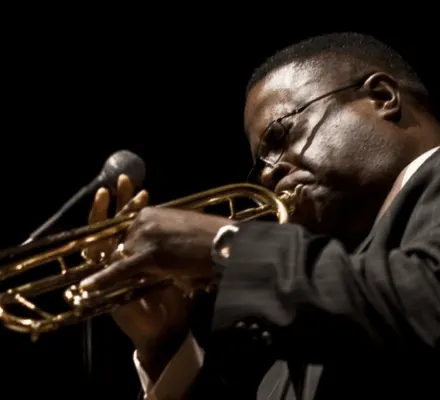 Close-up image of a man playing the trumpet.