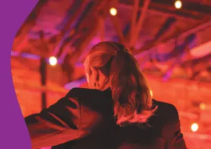 Backshot of a female conductor with her hair in a ponytail.