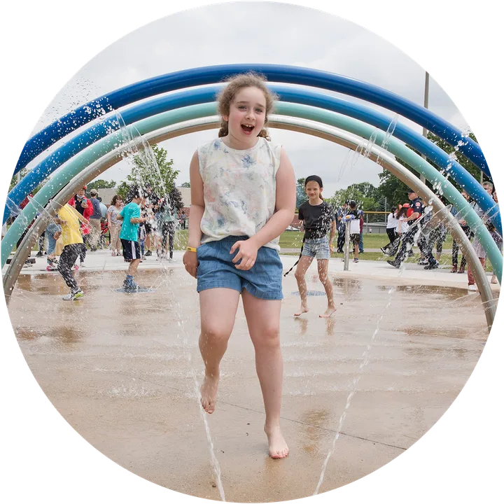 Child playing in a City operated splashpad.